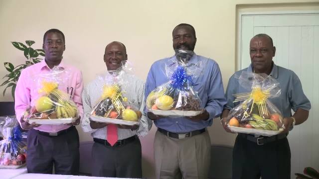 The Nevis Customs and Excise Division honours retired Customs Officers with fruit baskets as a token of appreciation on International Customs Day at Long Point on January 26, 2017. (L-r) Lester Liburd, Oriel Hanley, Sévil Hanley and Denzil “Chip” Moven